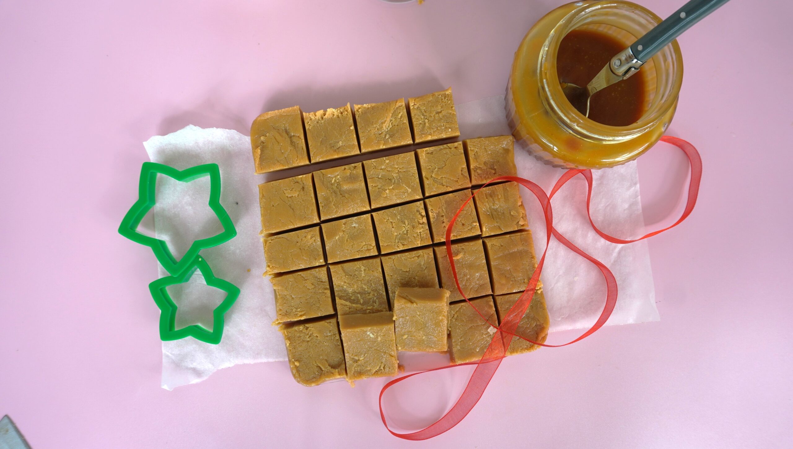 Cut up caramel fudge with a jar of caramel