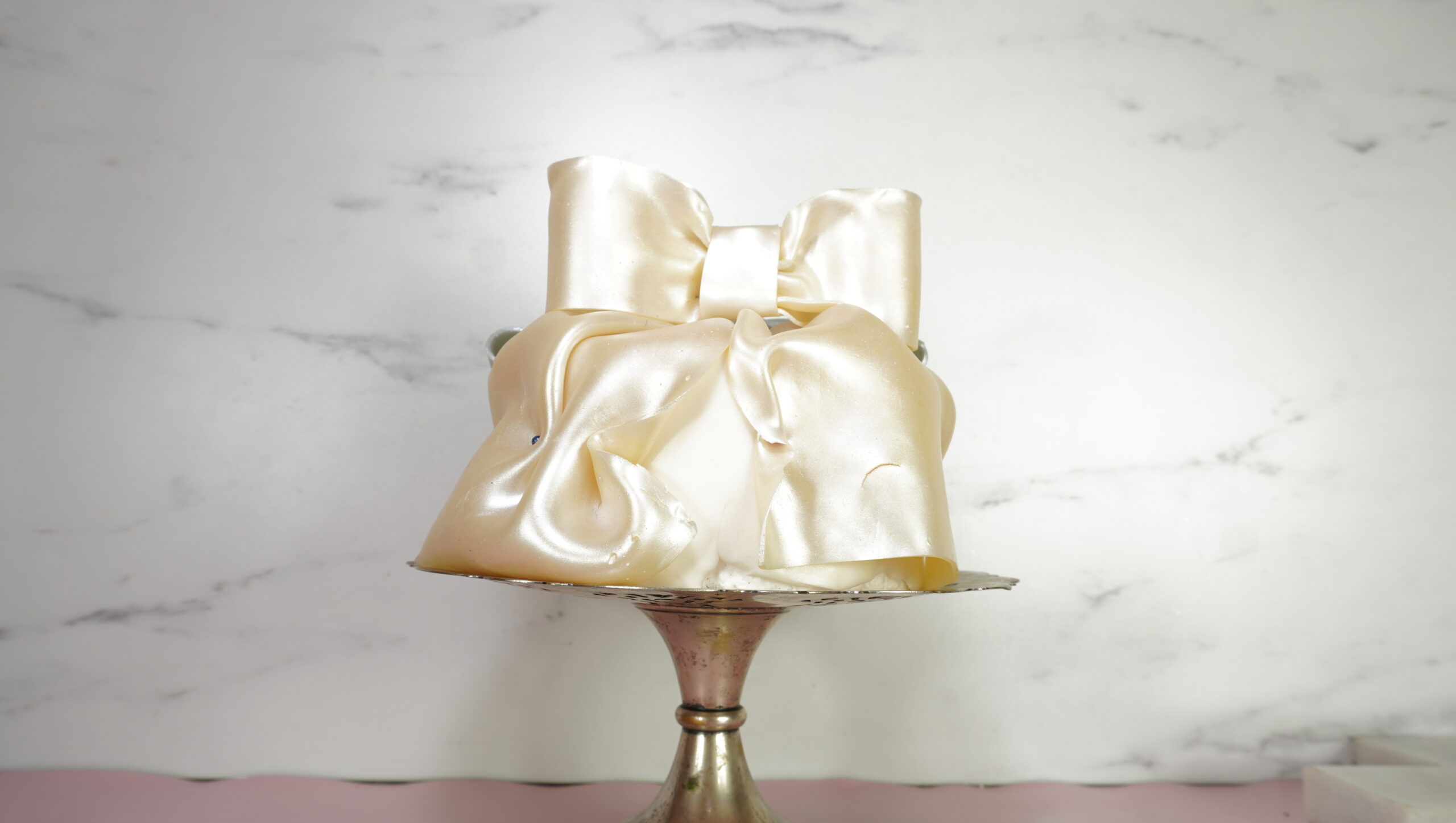 edible fabric bow on top of a cake